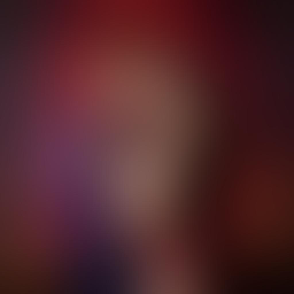 A playful and seductive scene featuring a couple in an artistic embrace, surrounded by various elements symbolizing desire and exploration, like silk ropes, playful masks, and soft candlelight. The background should be a dreamy blend of deep reds and purples, exuding warmth and intrigue. The couple should have confident expressions, showcasing their connection and adventure in intimacy. This image should evoke a sense of both courtship and ecstasy. vibrant colors. super-realistic. soft focus.